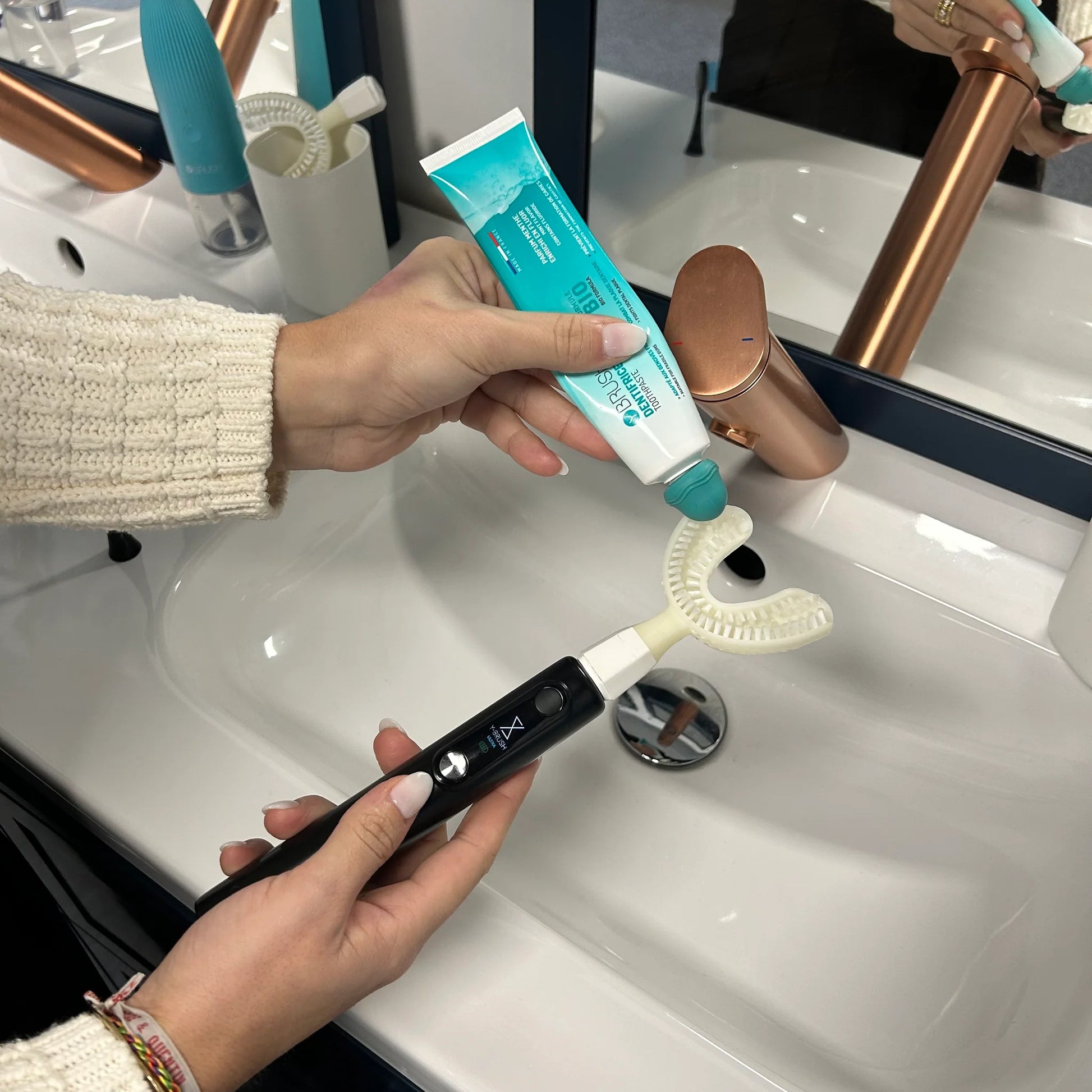 view of how you put toothpaste on a Y-Brush Ultra Premium - Electric Sonic Toothbrush for Adult with accessories