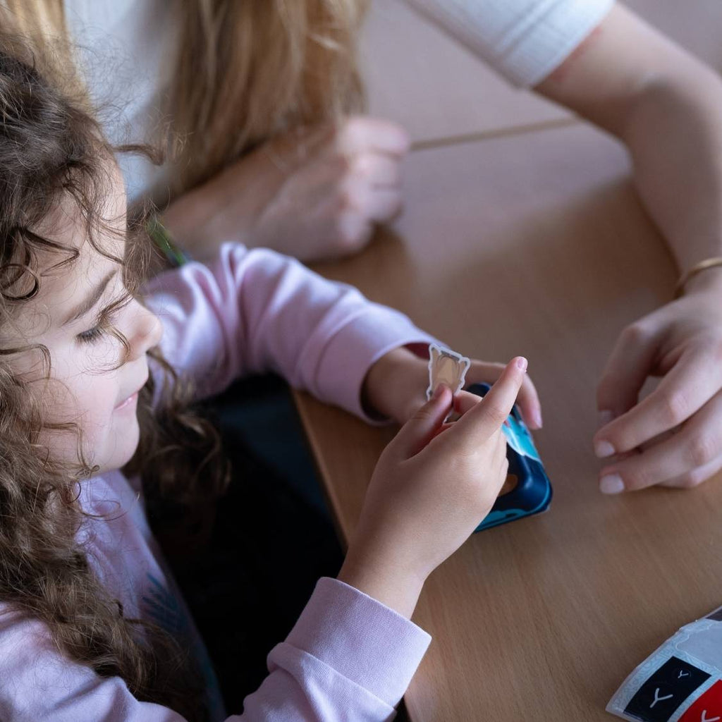 A child putting a sticker on a toothbrush